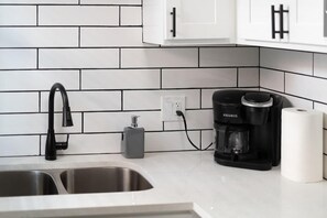 Coffee/tea maker, fridge, cookware/dishes/utensils