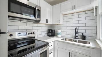 Fridge, stovetop, coffee/tea maker, cookware/dishes/utensils