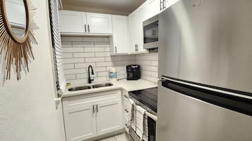 Fridge, stovetop, coffee/tea maker, cookware/dishes/utensils