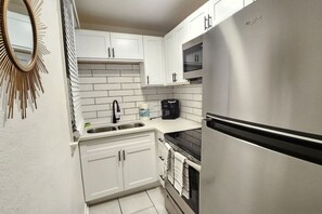 Fridge, stovetop, coffee/tea maker, cookware/dishes/utensils