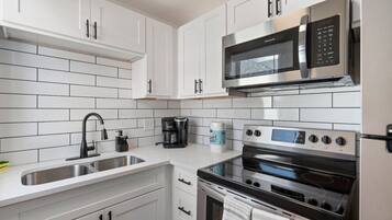 Fridge, stovetop, coffee/tea maker, cookware/dishes/utensils