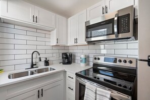 Fridge, stovetop, coffee/tea maker, cookware/dishes/utensils