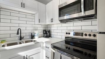 Fridge, coffee/tea maker, cookware/dishes/utensils