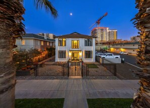 A two-story house with a gated entrance, a driveway, and a parking area. - Modern Apartment in the Heart of Phoenix (10) (Phoenix)