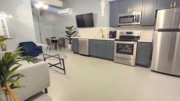 Fridge, microwave, coffee/tea maker, cookware/dishes/utensils