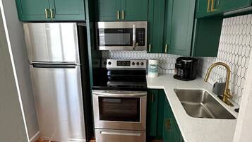 Fridge, microwave, coffee/tea maker, cookware/dishes/utensils
