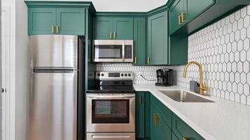 Fridge, microwave, coffee/tea maker, cookware/dishes/utensils
