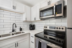 Fridge, stovetop, coffee/tea maker, cookware/dishes/utensils