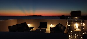 Relax on the balcony with a serene view of the water below.