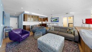 A modern living room with a sofa, a purple chair, a bean bag, and a patterned ottoman. - La Jolla Ocean Front Escape (San Diego)