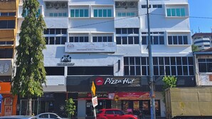 A multi-story building with signage for 'Wisma Low HAI WHAN' and 'POLITEKNIK KUALA TERENGGANU'.