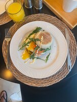 A plate of food with a fork and knife on a woven placemat.