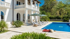 A large house with a swimming pool, outdoor furniture, and lush greenery. - Relax like a Renaissance nobleman in the six rooms of Villa Trsteno  (Trsteno)