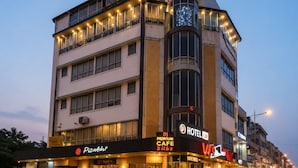 A hotel with a prominent 'UR HOTEL' sign, a 'Pizza Hut' restaurant, and a 'Premium Cafe' on the ground floor.