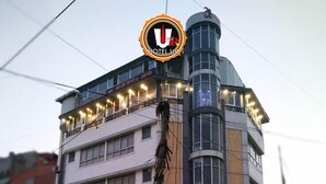 A multi-story hotel with a prominent 'HOTEL UR' sign, a 'CAFE' sign, and a 'Pizza Hut' restaurant on the ground floor. - Hotel Ur (Prayagraj)