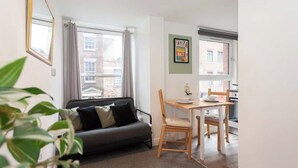 A compact living space with a sofa, dining table, and chairs. - £ - City Centre - Duke Street Studio ~ 5* Location (Liverpool)