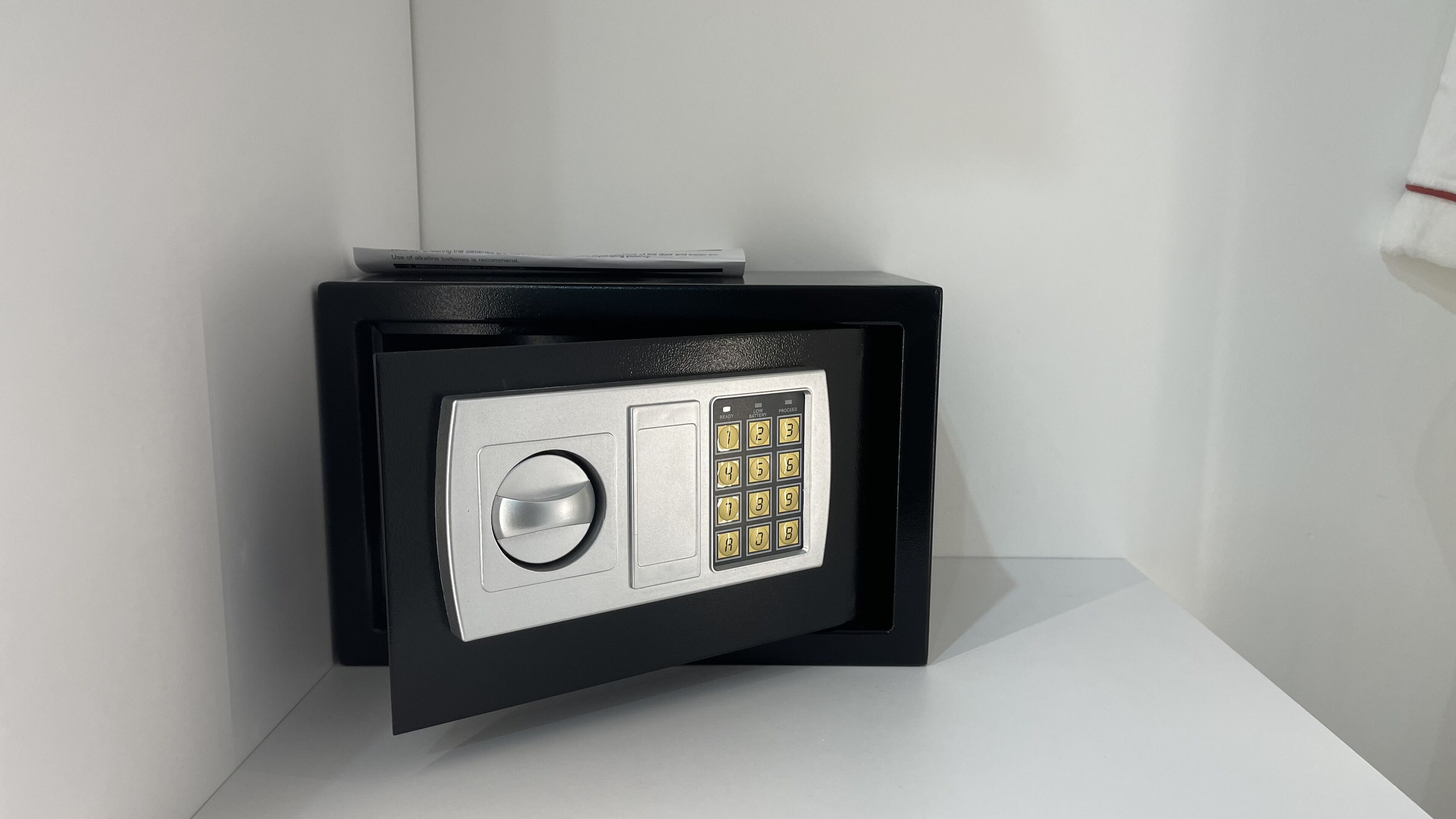 A safe deposit box with a combination lock and a keyhole.