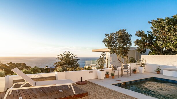 A rooftop terrace with a pool, lounge chairs, and potted plants. - View 16 | Boho Bliss (Cape Town)