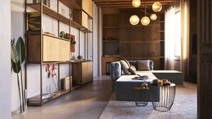 A modern living room with a sofa, coffee table, and shelving unit. - Fornace Suite (Florence)
