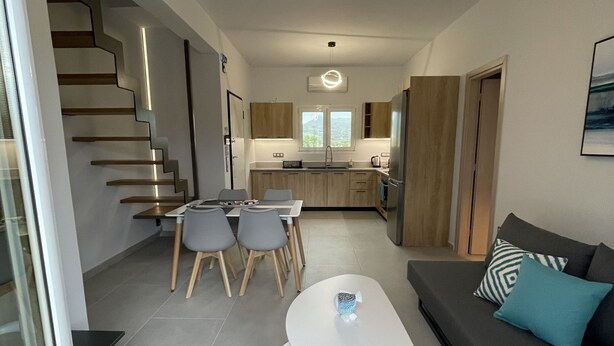 A modern interior with a staircase, dining area, kitchen, and living space. - Villa Rodelia in Roda 2bedroom nr3 (Roda)