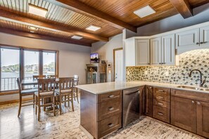 Enjoy meals in the kitchen with a central island and dining area, featuring a dishwasher and a view of the outside.
