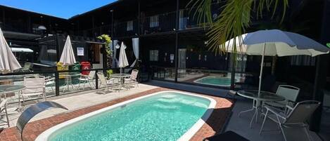 Relax by the inviting pool surrounded by comfortable lounge chairs and umbrellas.