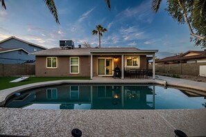 A house with a swimming pool, patio, and a covered outdoor seating area. - Luxury Home w/ Heated Pool & Golf Access (Scottsdale)