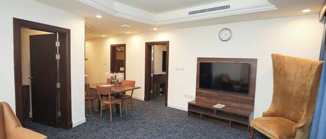 Family Suite | Living room | 55-inch Smart TV with satellite channels