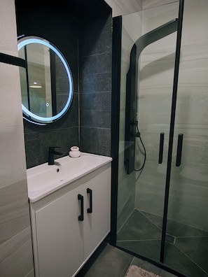 Shower, hair dryer, towels, soap