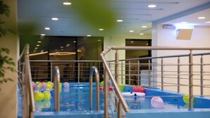 An indoor pool area with a metal railing and colorful balls. - GUEST HOUSE FOR HOTELS APARTMENTS - جيست هاوس للشقق الفندقيه (Yanbu)