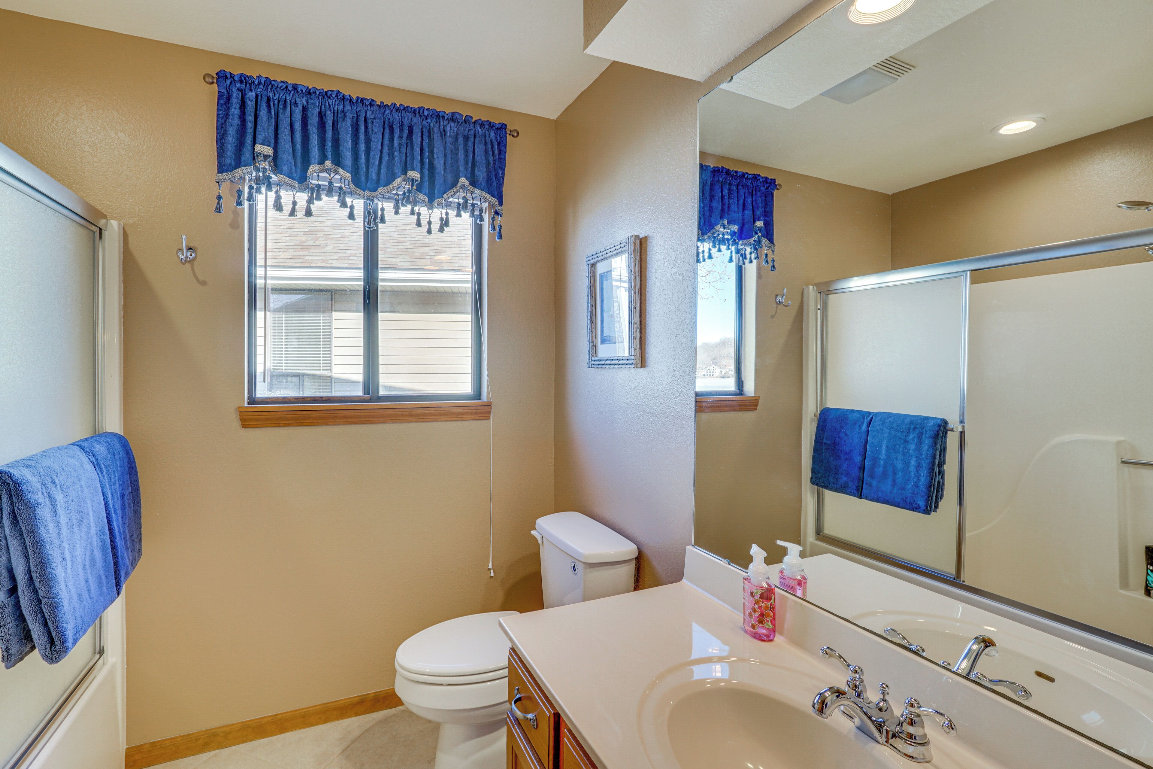 A bathroom with a toilet, sink, and shower.