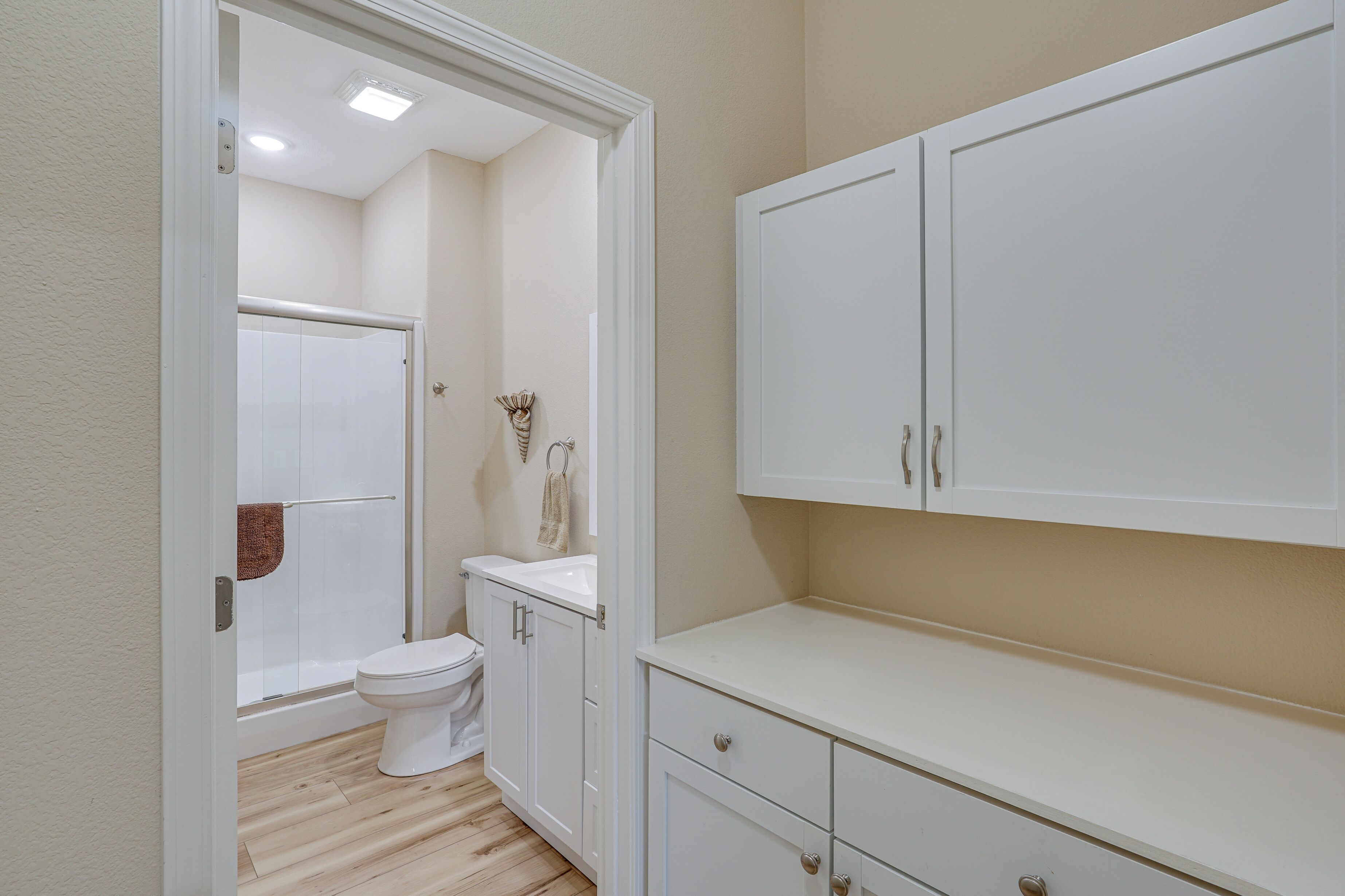 A bathroom with a toilet, a shower, and a sink.