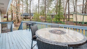 A deck with a round table and chairs, surrounded by a wooden deck and a railing. - Pet-friendly Fletcher Home - 13 Mi to Asheville! (Fletcher)