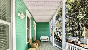 A porch with wicker furniture and a white bench. - Seaside, FL Beach Home - Close to Pool & Beach; + 2 Adult Bikes! (Santa Rosa Beach)