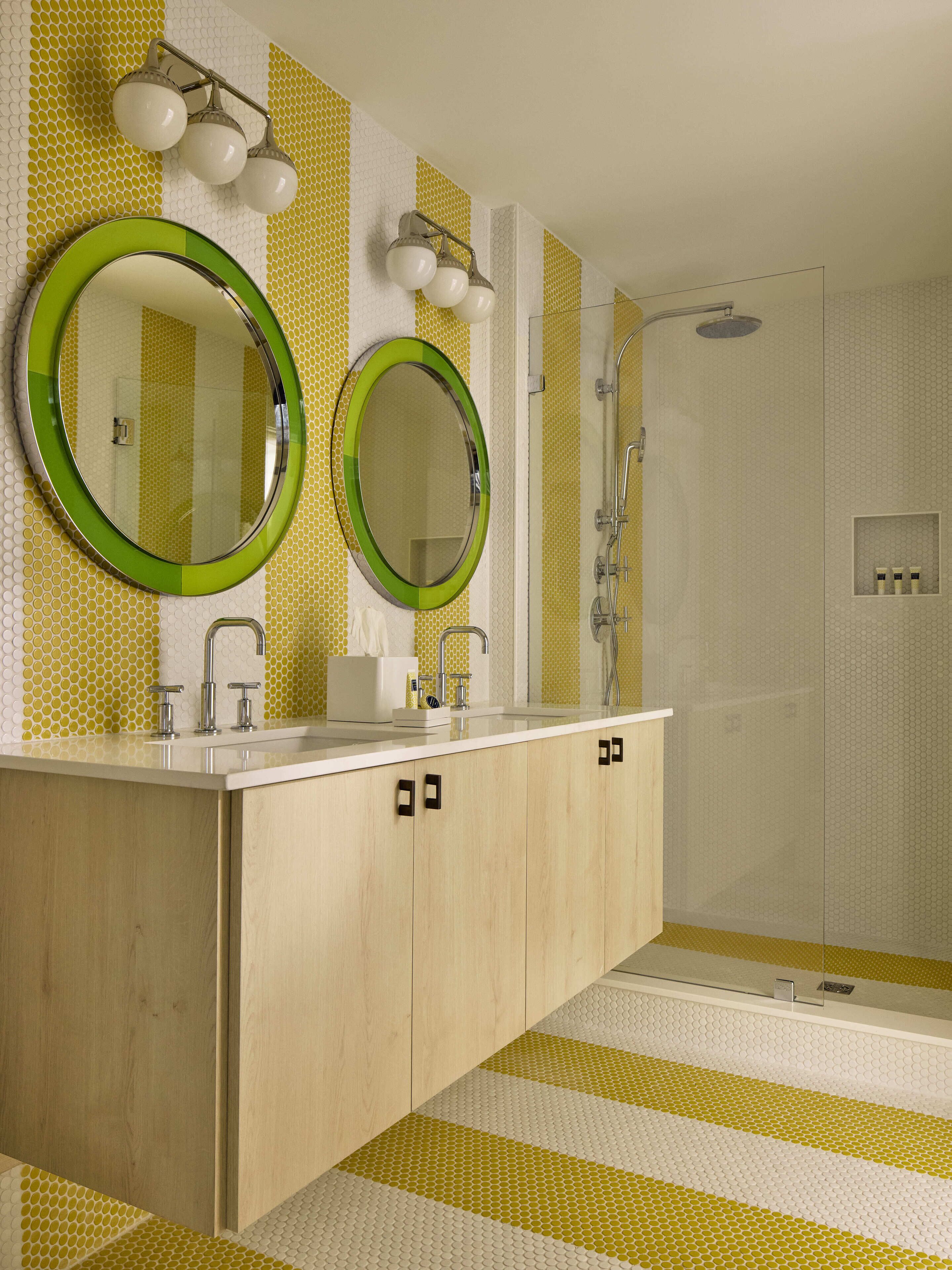 A bathroom with two mirrors, a sink, and a shower.