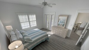 A bedroom with a bed, dresser, nightstand, and a ceiling fan. - Newly Renovated Condo in Sunny Naples, FL (Naples)