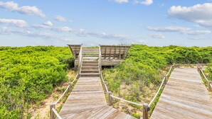 A wooden boardwalk leading to a wooden structure with a staircase. - Heaven's Nest -- First Floor Duck Condo with direct access to Beach and Pool (Kitty Hawk)