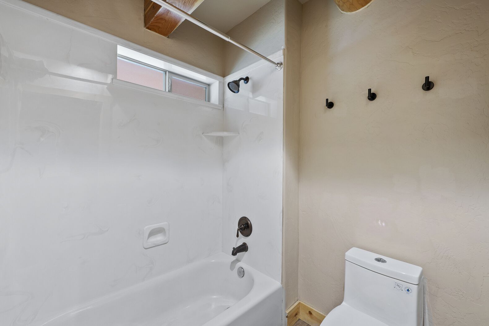 A bathroom with a bathtub, a shower, and a toilet.
