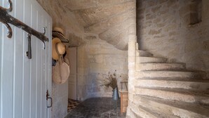 A stone staircase leading to a door with a white panel.