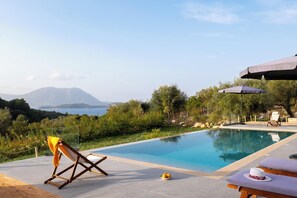 Surrounded by lush greenery, this tranquil retreat offers a serene mountain view and a refreshing pool with lounge area.