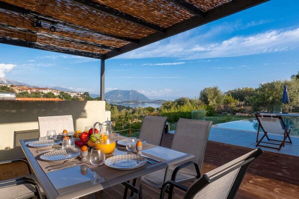 Enjoy a romantic breakfast for two in this serene outdoor dining area overlooking a scenic landscape.