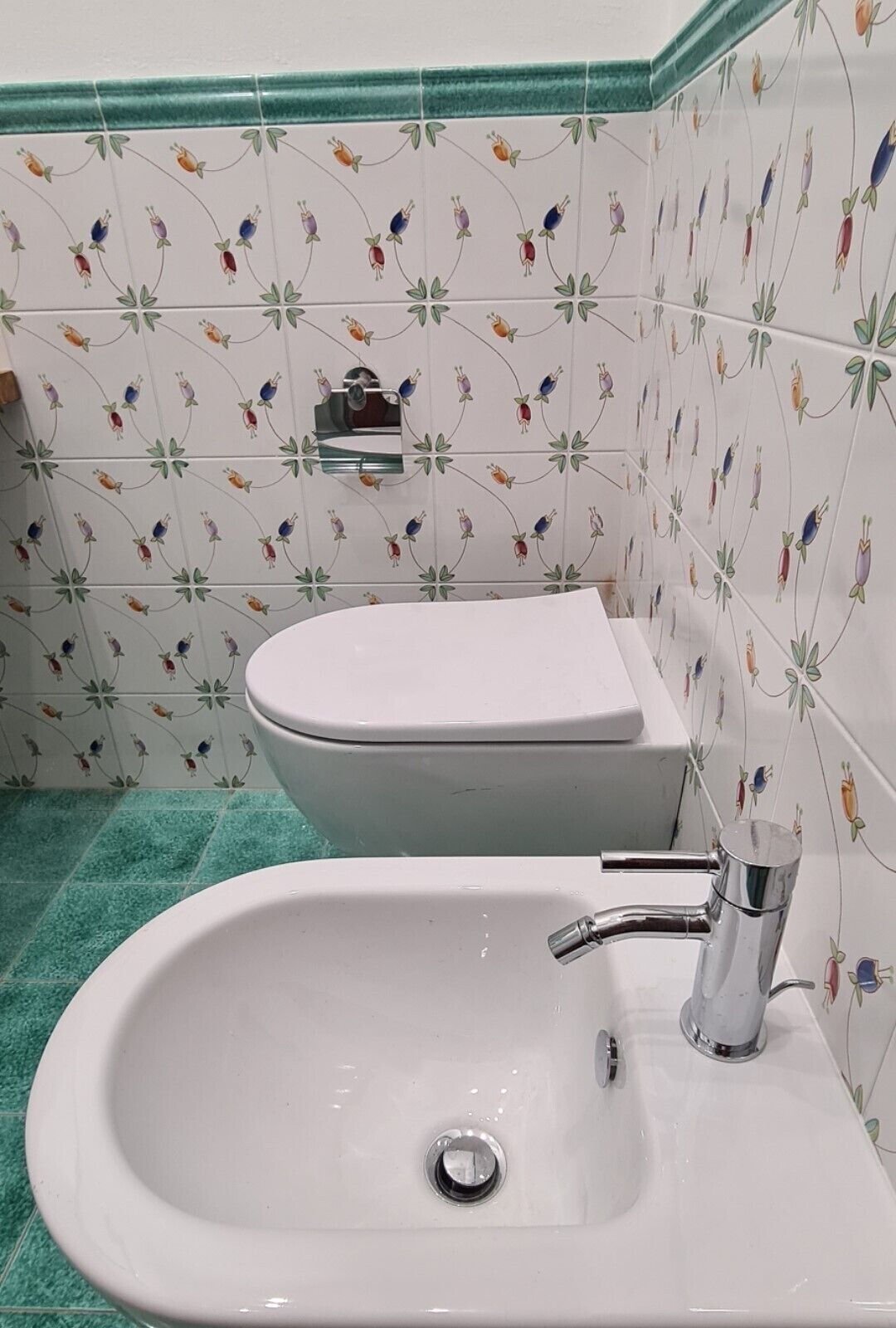 A bathroom with a white sink, a toilet, and a shower area.