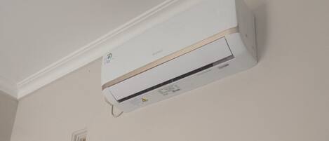 A white air conditioning unit mounted on a wall.