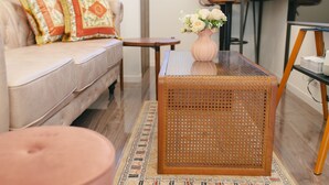 A living room with a sofa, a coffee table, and a chair.
