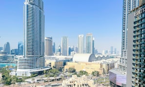 A high-rise building with a modern design, surrounded by other tall buildings, indicating a densely populated urban area.