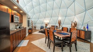 A modern kitchen with wooden cabinets and a built-in microwave. - Traverse City - Luxury on the Edge - 10 (Williamsburg)