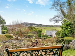A bench overlooking a rural landscape with a view of houses and fields. - The Cottage at Breeze Hill (Carr Bank, near Arnside)