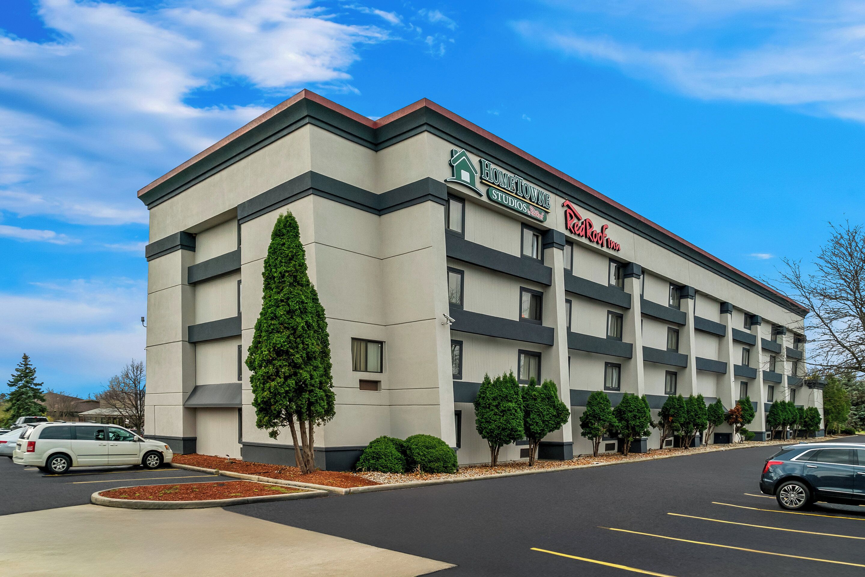 A hotel with a modern design, featuring a flat roof and a large sign for 'Bonetowne Studios'.