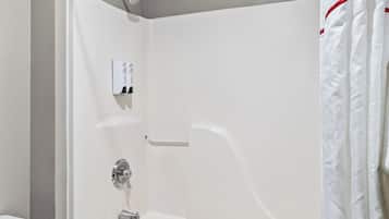 A white shower enclosure with a control panel, a towel rack, and a shower curtain.