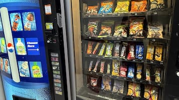 A vending machine with Pepsi and a snack vending machine with various brands.